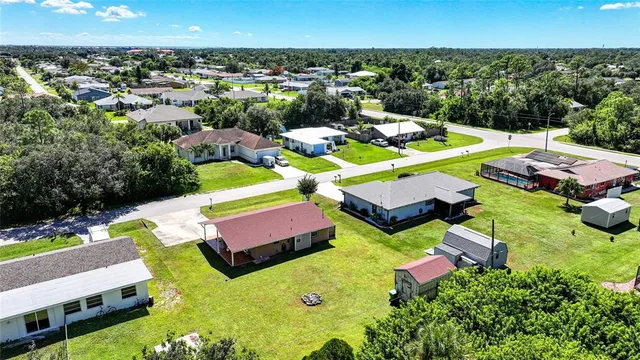 an aerial view of residential houses with outdoor space and swimming pool