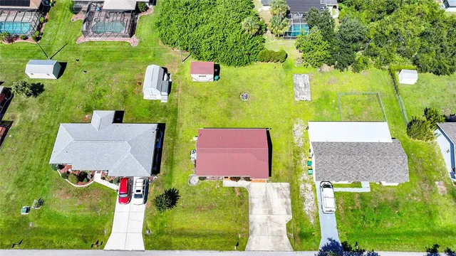 an aerial view of residential houses with outdoor space and street view