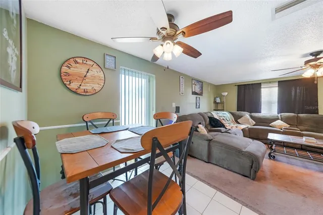 a living room with furniture a clock and a window