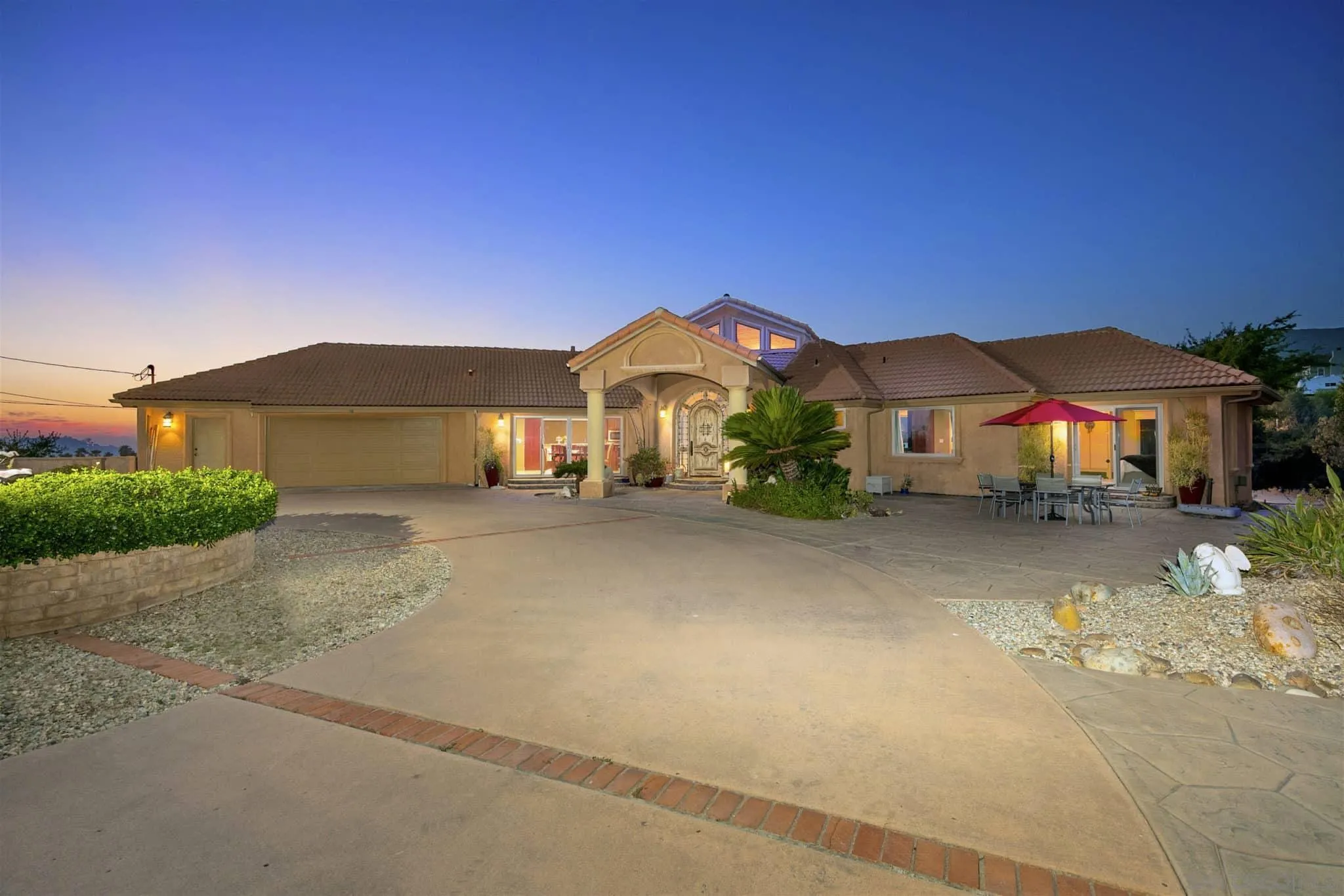 a front view of a house with a yard and a garage