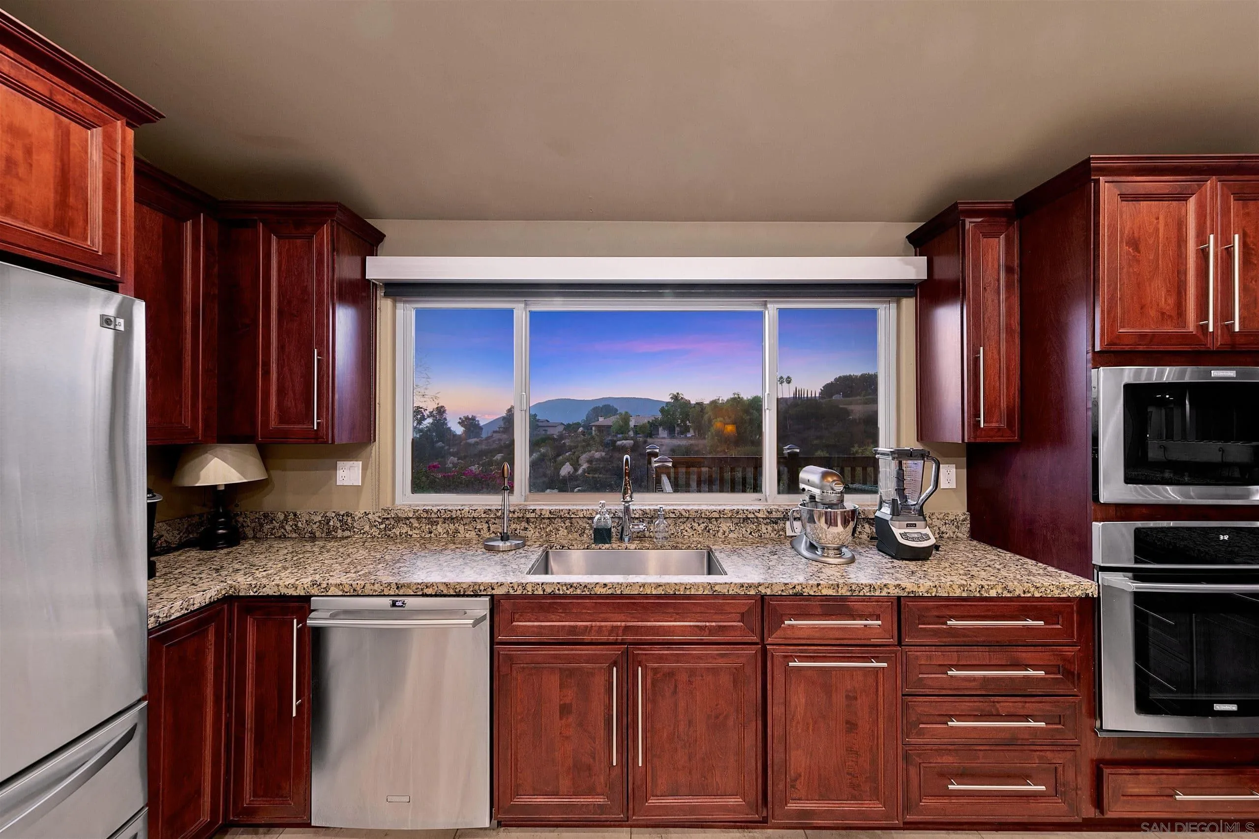 3480 Hidden Trail Drive Jamul, CA 91935 - Photo 11 of 38 a kitchen with stainless steel appliances granite countertop a sink stove and refrigerator