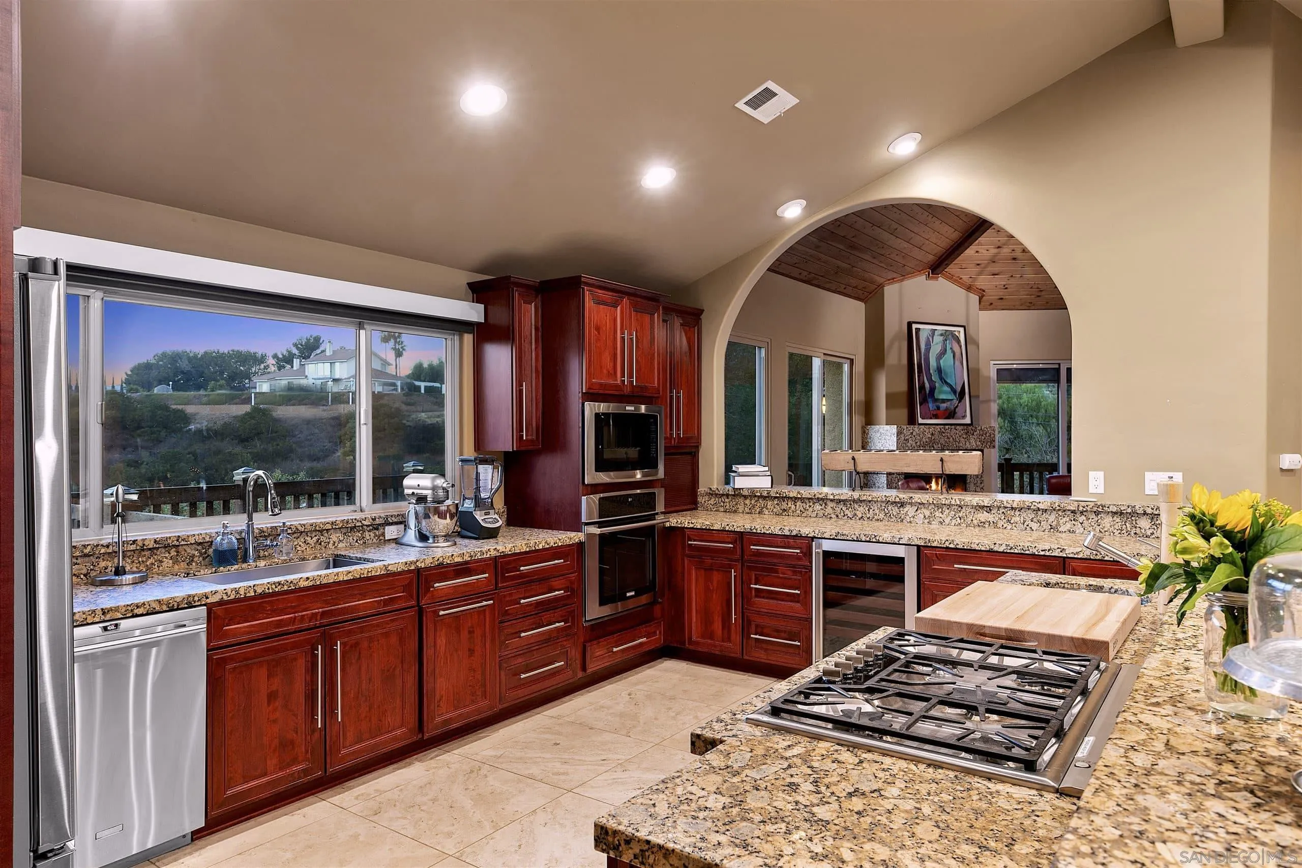 3480 Hidden Trail Drive Jamul, CA 91935 - Photo 12 of 38 a large kitchen with kitchen island granite countertop a stove a sink and a large countertops with wooden floor