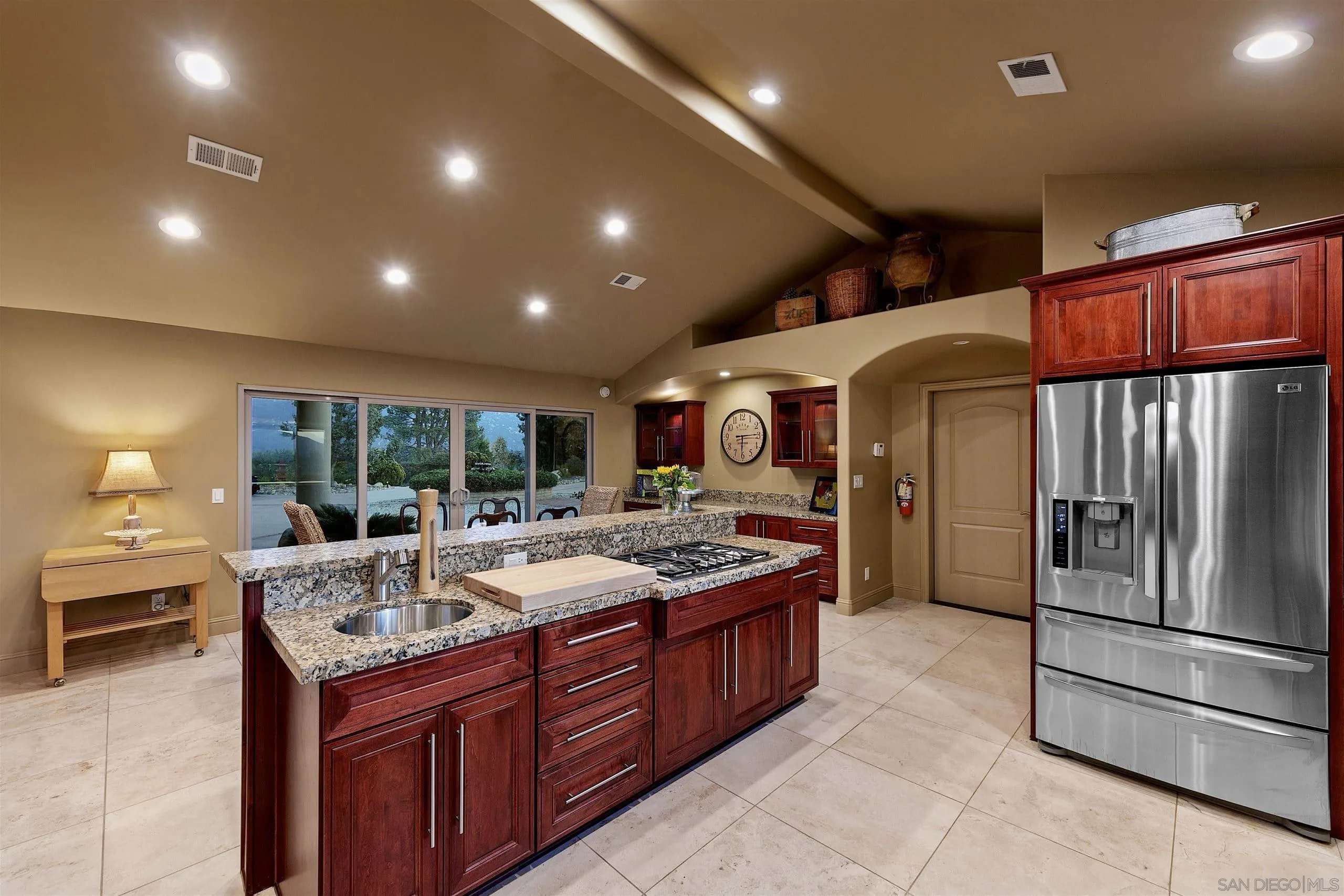 3480 Hidden Trail Drive Jamul, CA 91935 - Photo 13 of 38 a large kitchen with kitchen island a large counter top stainless steel appliances and cabinets