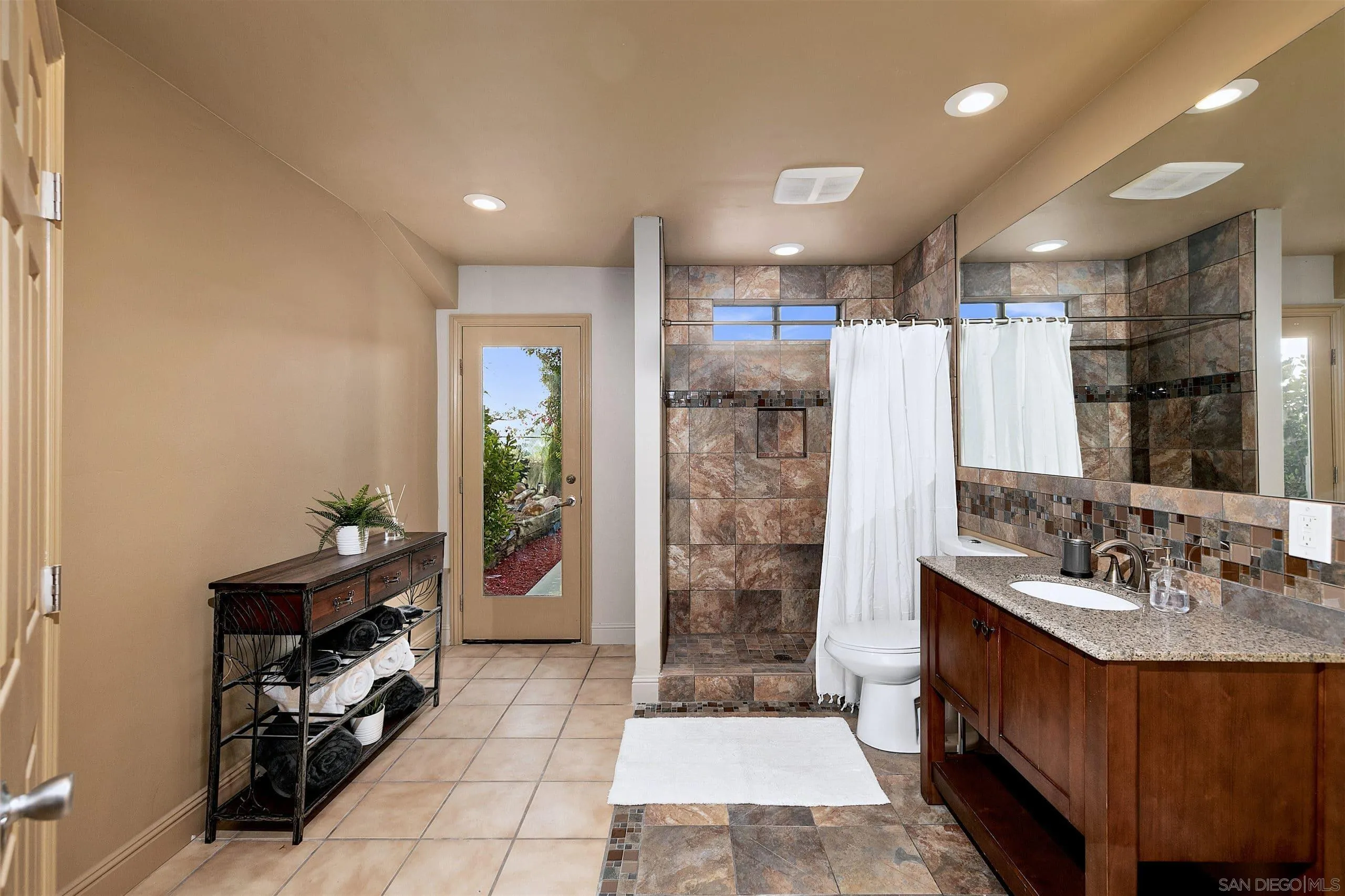 3480 Hidden Trail Drive Jamul, CA 91935 - Photo 15 of 38 a bathroom with a double vanity sink a mirror and a shower