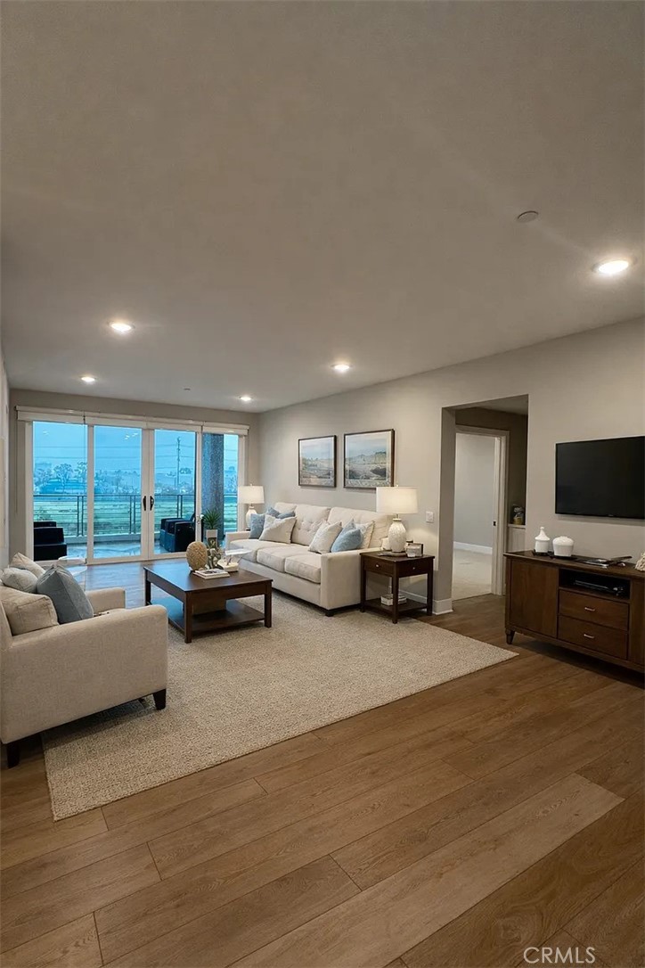 16450 Veterans Way, Unit 308 Tustin, CA 92782 - Photo 2 of 11 a living room with furniture and a flat screen tv