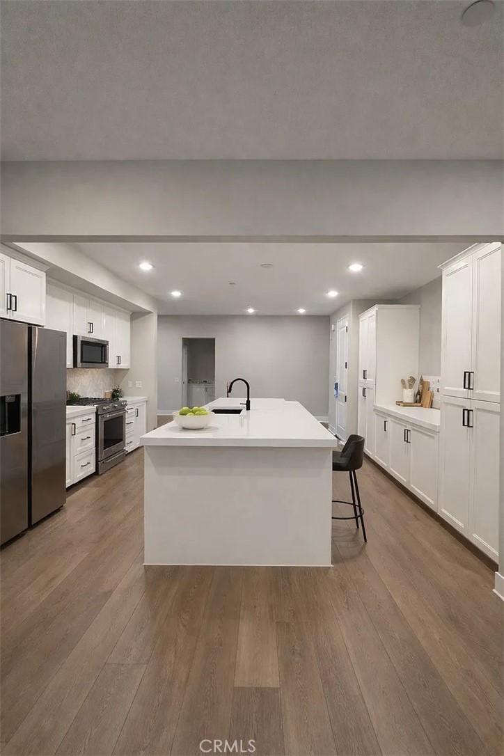 16450 Veterans Way, Unit 308 Tustin, CA 92782 - Photo 4 of 11 a view of kitchen with wooden floor