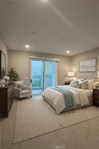a spacious bedroom with a bed and glass window