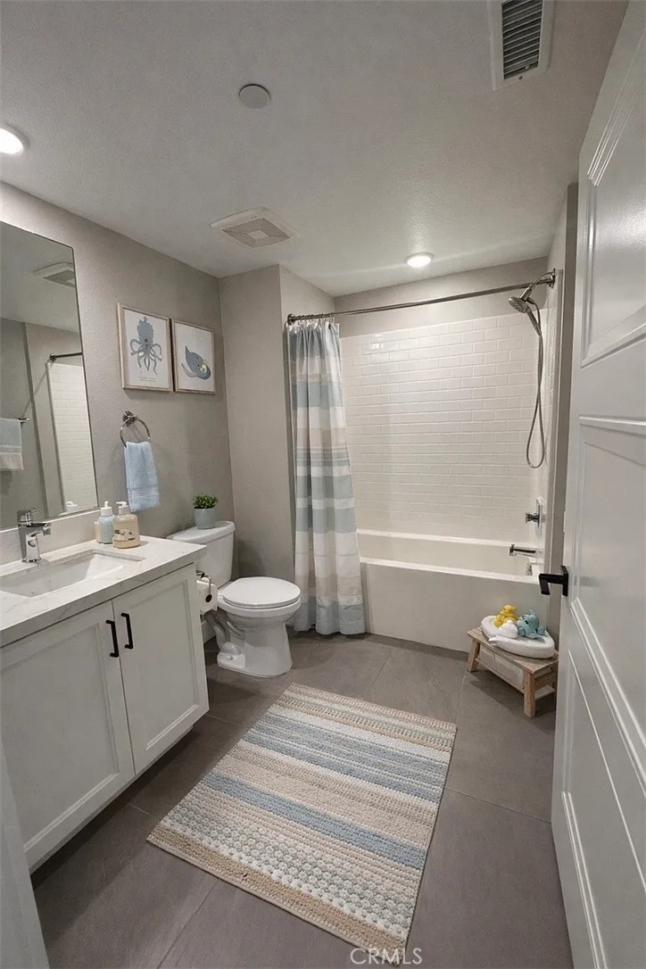 16450 Veterans Way, Unit 308 Tustin, CA 92782 - Photo 9 of 11 a bathroom with a double vanity sink toilet and shower