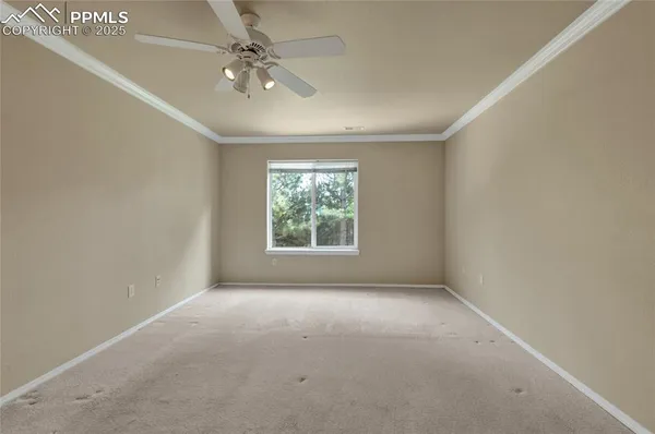 a view of an empty room with a ceiling fan