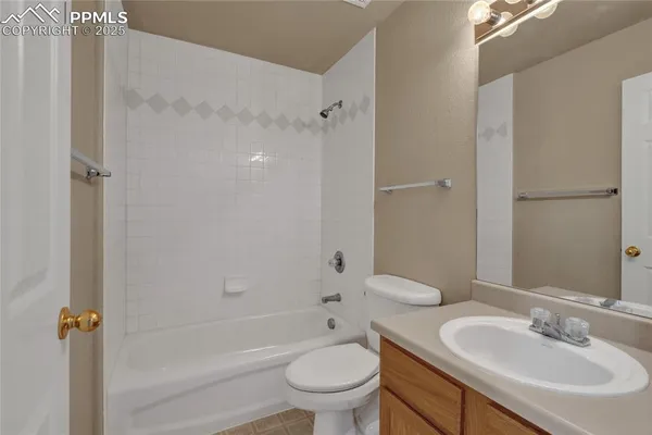 a bathroom with a granite countertop sink a toilet and shower