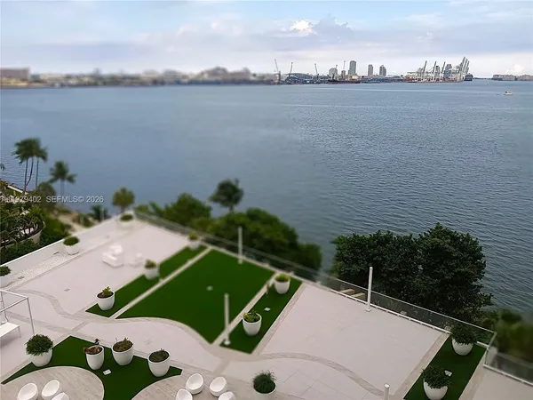 a view of a patio with couches table and chairs potted plants