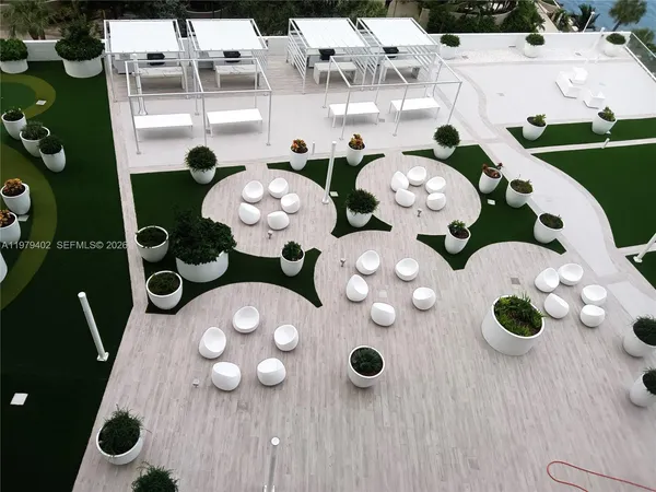 a view of living room filled with furniture and large window