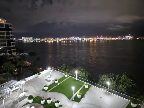 a view of a room with wooden floor and a window