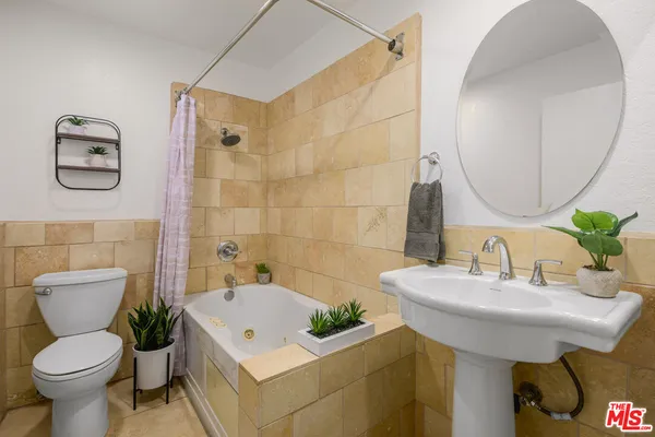 a bathroom with a sink toilet and a mirror