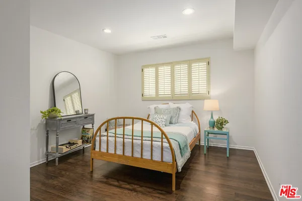 a bedroom with a bed chair and a window