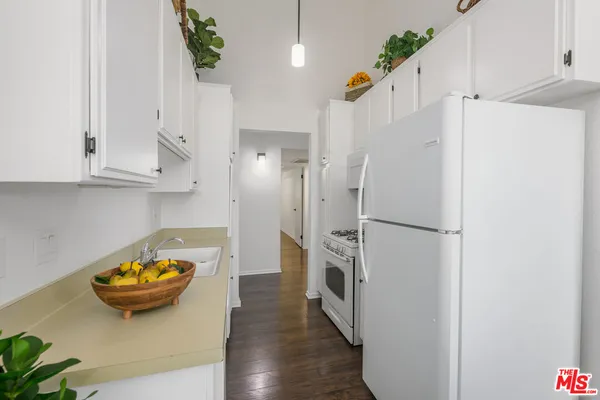 a kitchen with stainless steel appliances and a refrigerator