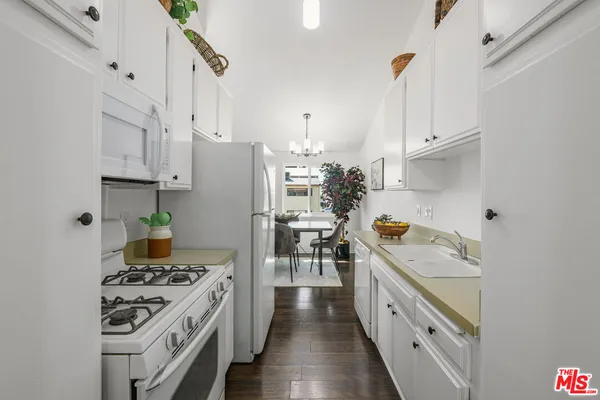 a kitchen with stainless steel appliances a stove a sink and a refrigerator