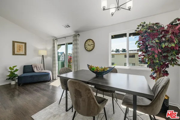 a view of a dining room with furniture and a chandelier