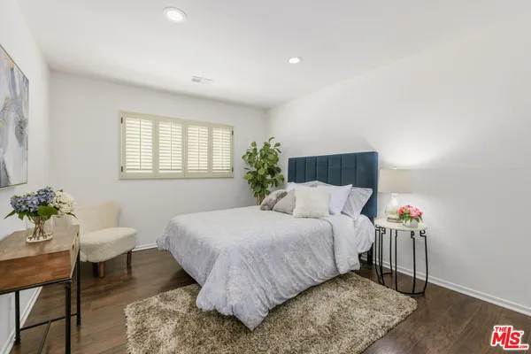 a bedroom with a bed and a table