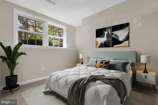 a bedroom with a bed and glass window