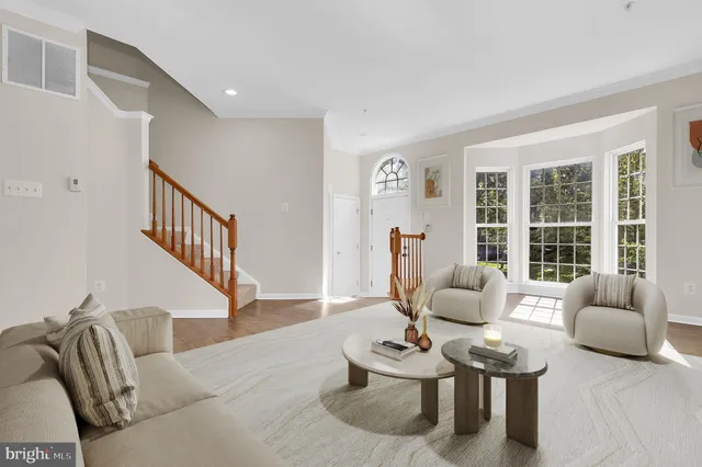 a living room with furniture rug and a large window
