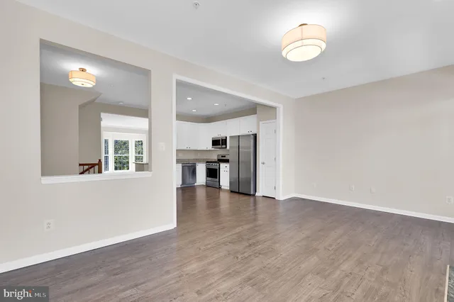 a view of empty room with wooden floor and fireplace
