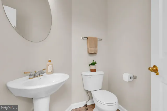 a bathroom with a sink mirror and toilet