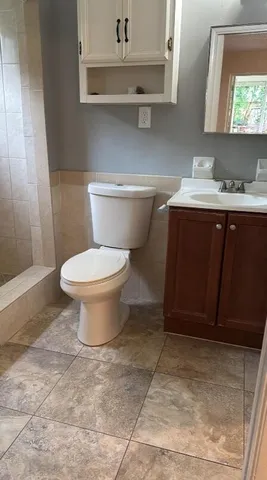 a bathroom with a sink toilet and mirror
