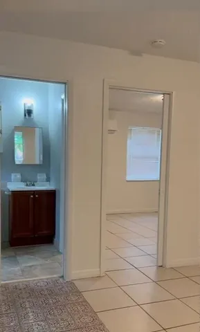 a view of bathroom with a sink and mirror
