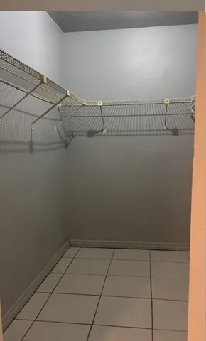 a view of kitchen with furniture and a refrigerator