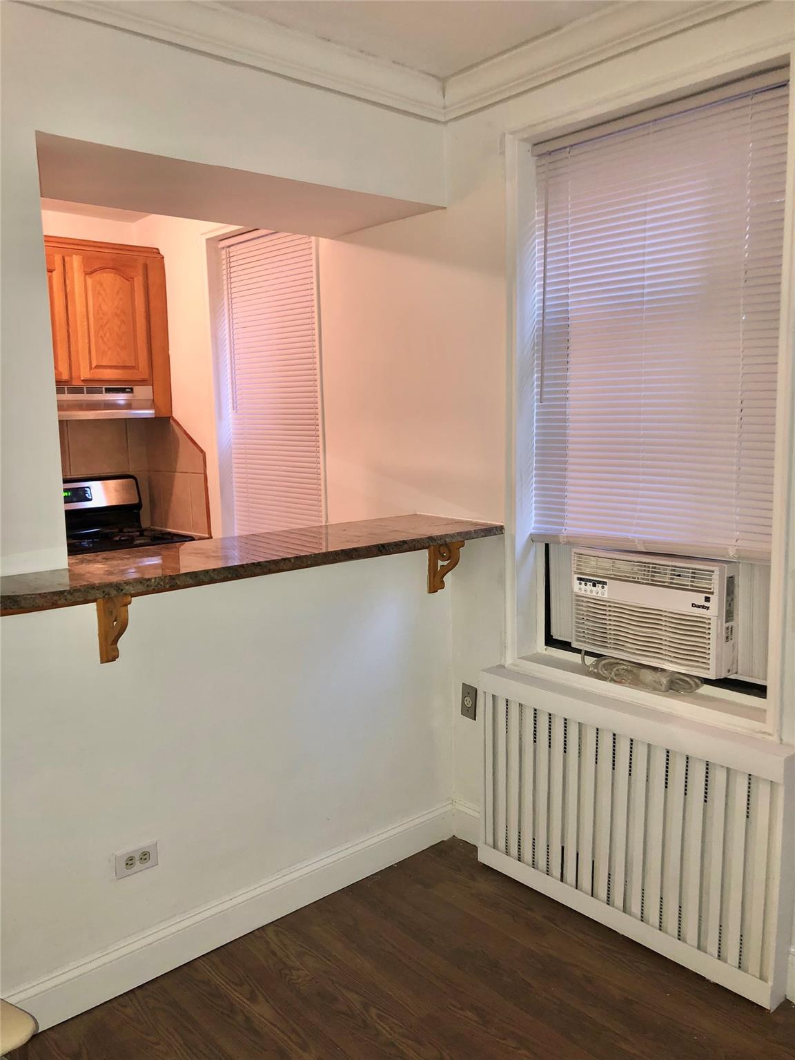 150-25 72nd Road, Unit 1E Queens, NY 11367 - Photo 5 of 7 a kitchen with a window a sink and a counter top space