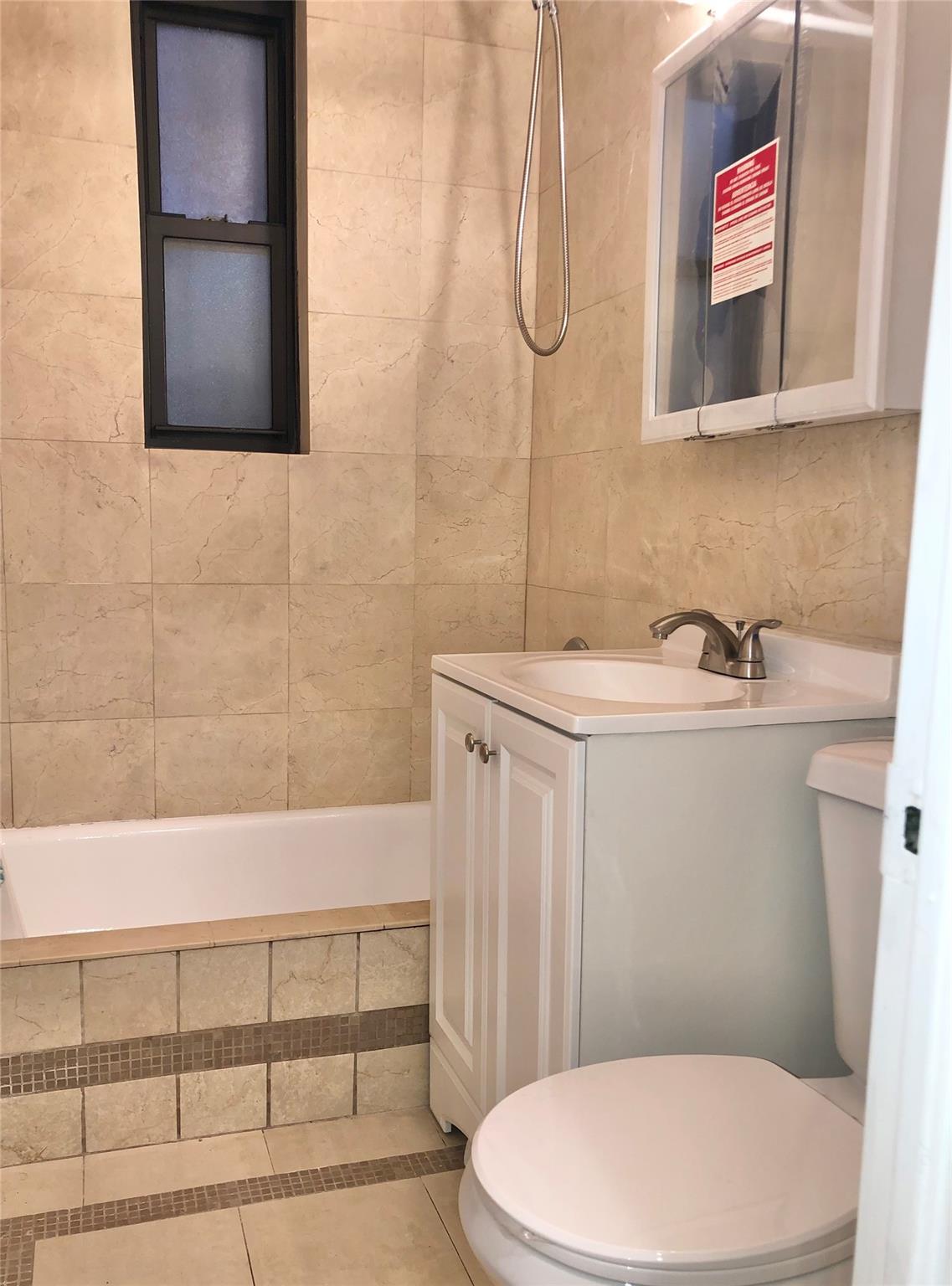 150-25 72nd Road, Unit 1E Queens, NY 11367 - Photo 6 of 7 a bathroom with a sink a toilet and shower