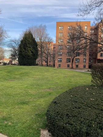 a view of a big yard with a building in the background