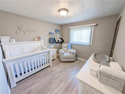 a bedroom with furniture and a wooden floor
