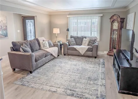 a living room with furniture wooden floor and a flat screen tv