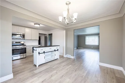 a view of kitchen with sink microwave and cabinets