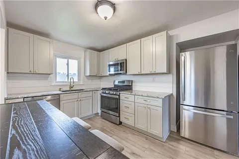 a kitchen with a refrigerator stove and sink