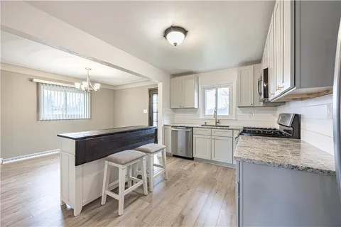 a kitchen with a stove a sink and a refrigerator
