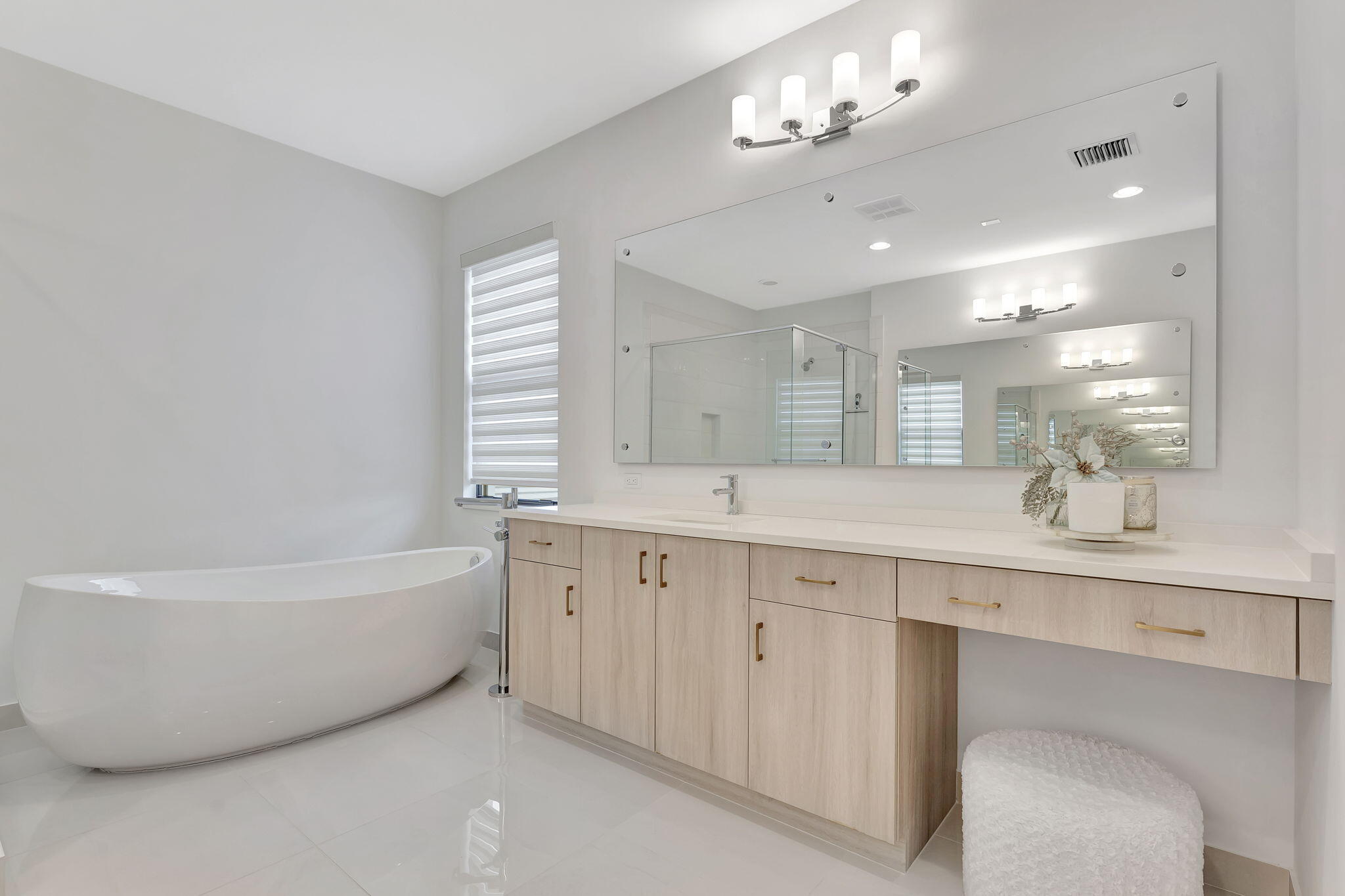 20046 Pacific Dunes Drive Boca Raton, FL 33434 - Photo 56 of 130 a bathroom with a bathtub a double vanity sink a mirror and a bathtub