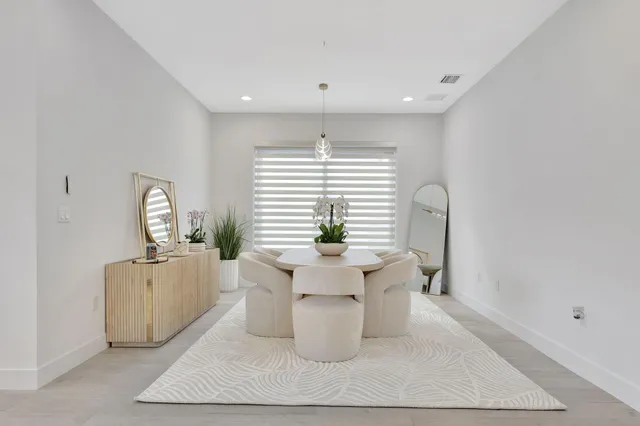 a view of a patio with a table and chairs next to a yard