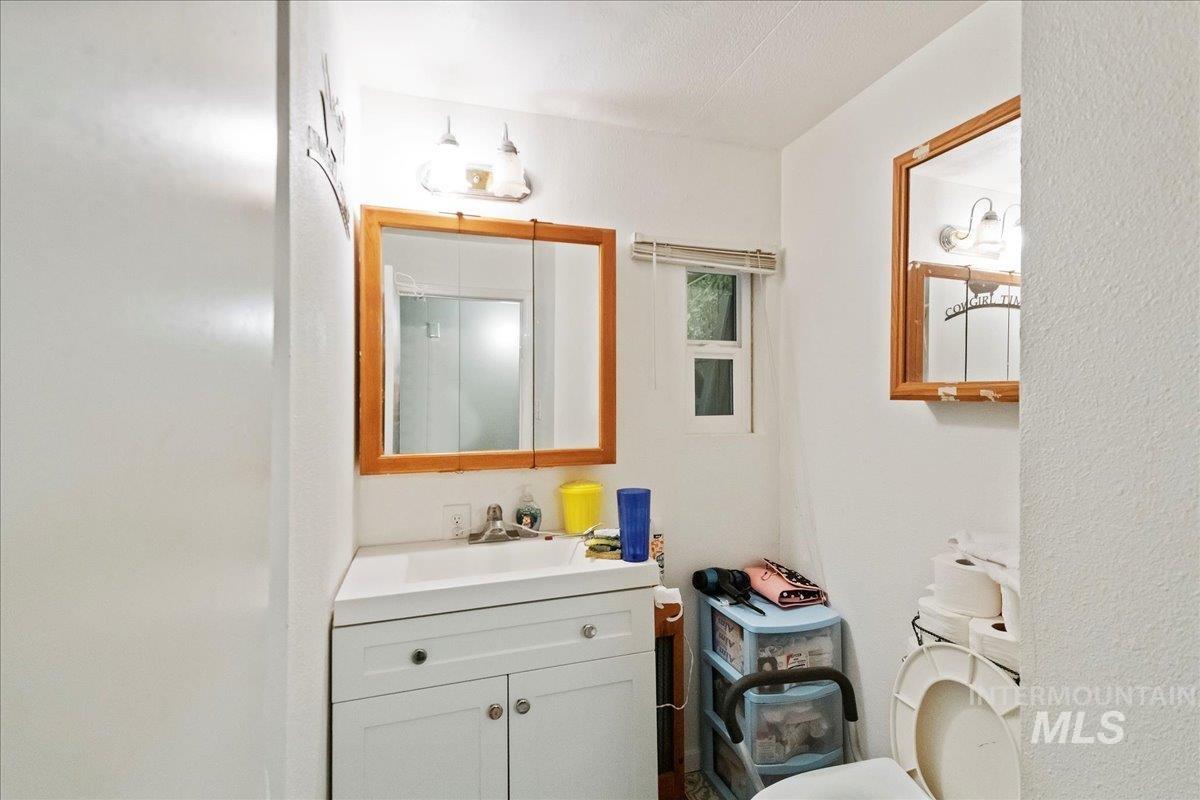15881 Purple Sage Road, Unit 15 Caldwell, ID 83607 - Photo 14 of 22 Half bath featuring vanity and toilet