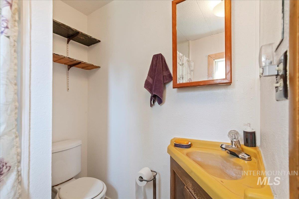 15881 Purple Sage Road, Unit 15 Caldwell, ID 83607 - Photo 15 of 22 Bathroom with vanity and a shower with shower curtain