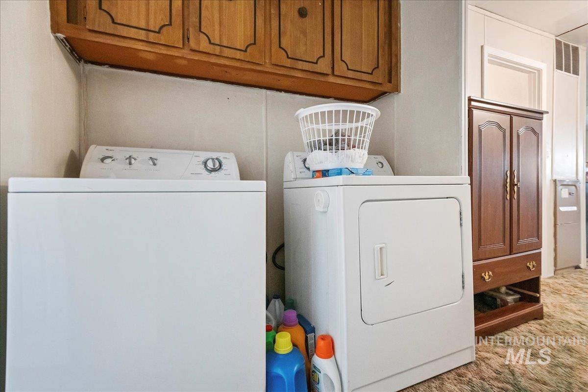 15881 Purple Sage Road, Unit 15 Caldwell, ID 83607 - Photo 16 of 22 Laundry room featuring separate washer and dryer and cabinet space