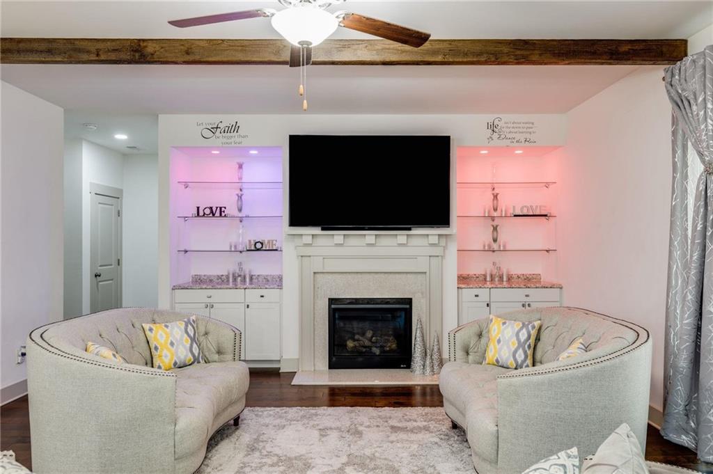 245 Crestbrook Lane Dallas, GA 30157 - Photo 12 of 47 a living room with a fireplace and a flat screen tv