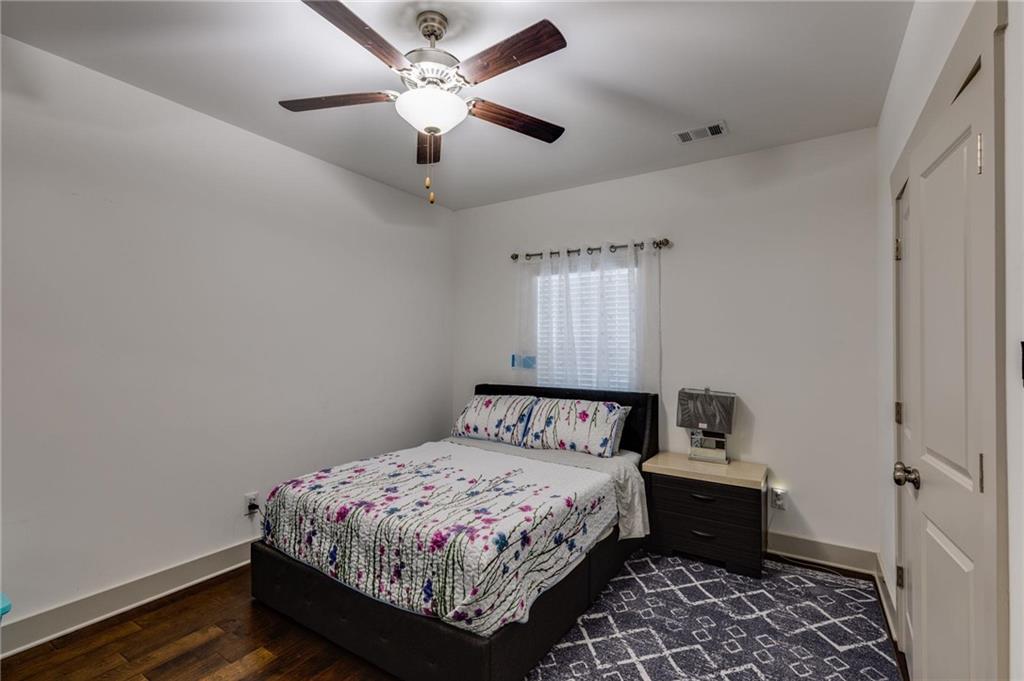 245 Crestbrook Lane Dallas, GA 30157 - Photo 18 of 47 a bedroom with a bed and a chandelier