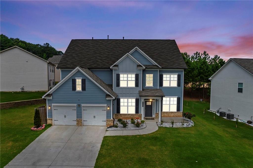 245 Crestbrook Lane Dallas, GA 30157 - Photo 2 of 47 a front view of a house with a yard fire pit and outdoor seating