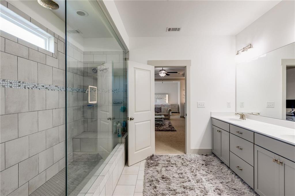 245 Crestbrook Lane Dallas, GA 30157 - Photo 27 of 47 a bathroom with a shower sink and mirror