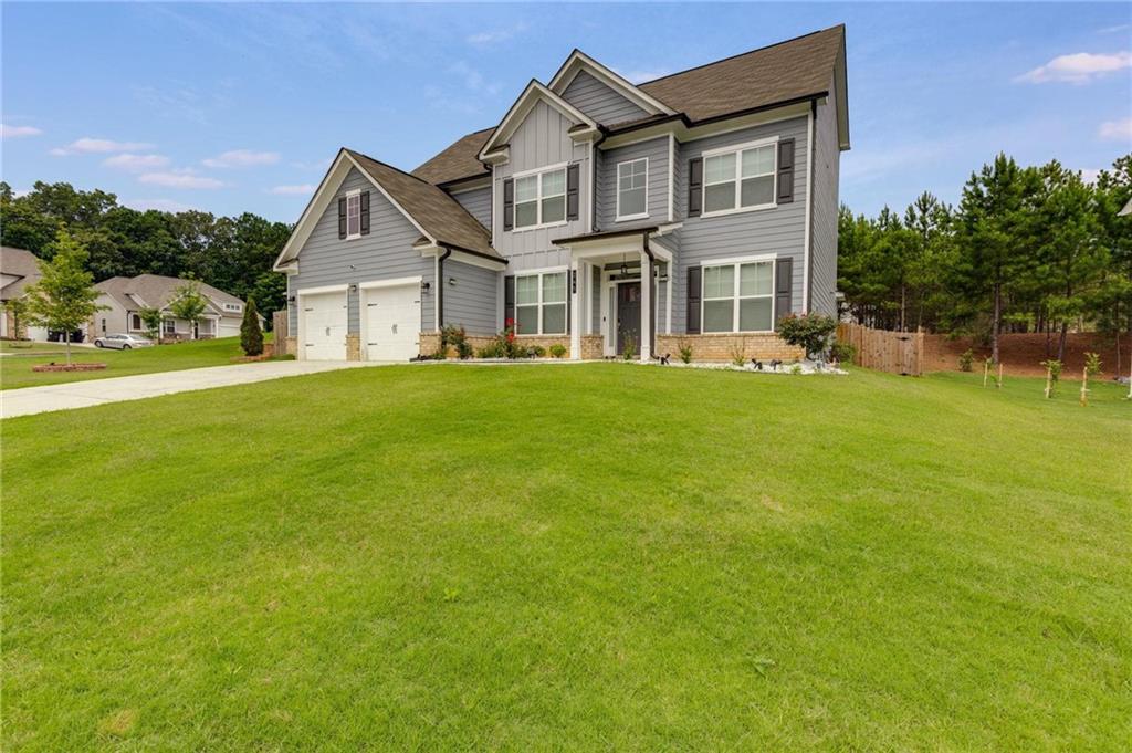 245 Crestbrook Lane Dallas, GA 30157 - Photo 3 of 47 a front view of a house with a garden