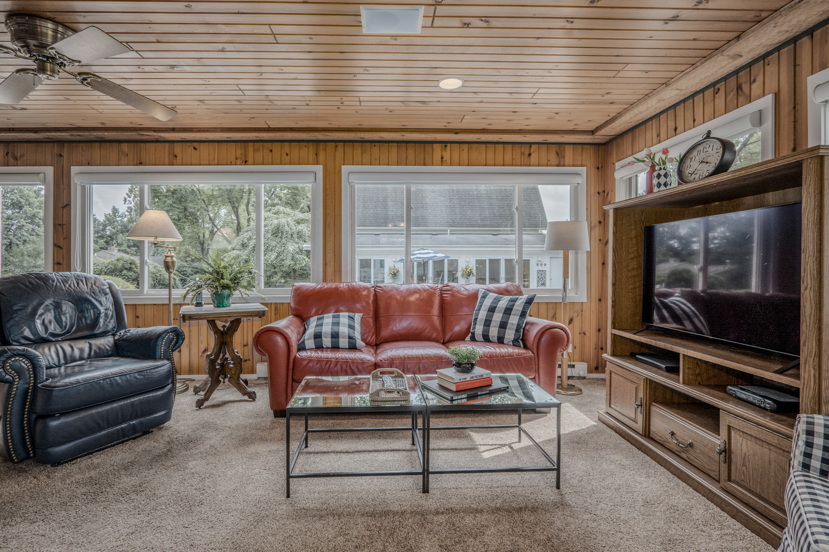 1530 Kaneville Road Geneva, IL 60134 - Photo 16 of 60 a living room with furniture a flat screen tv and a floor to ceiling window