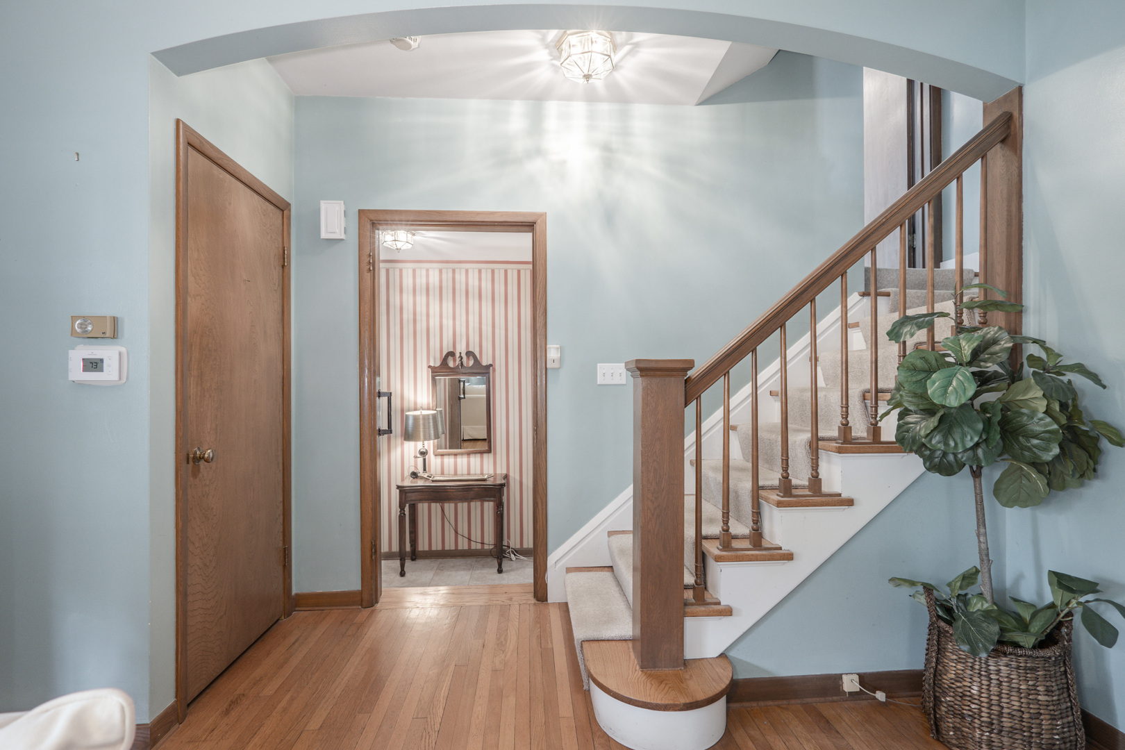 1530 Kaneville Road Geneva, IL 60134 - Photo 7 of 60 a view of staircase with wooden floor and a potted plant